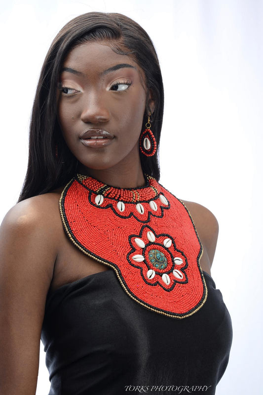 black model with red beaded collar necklace
