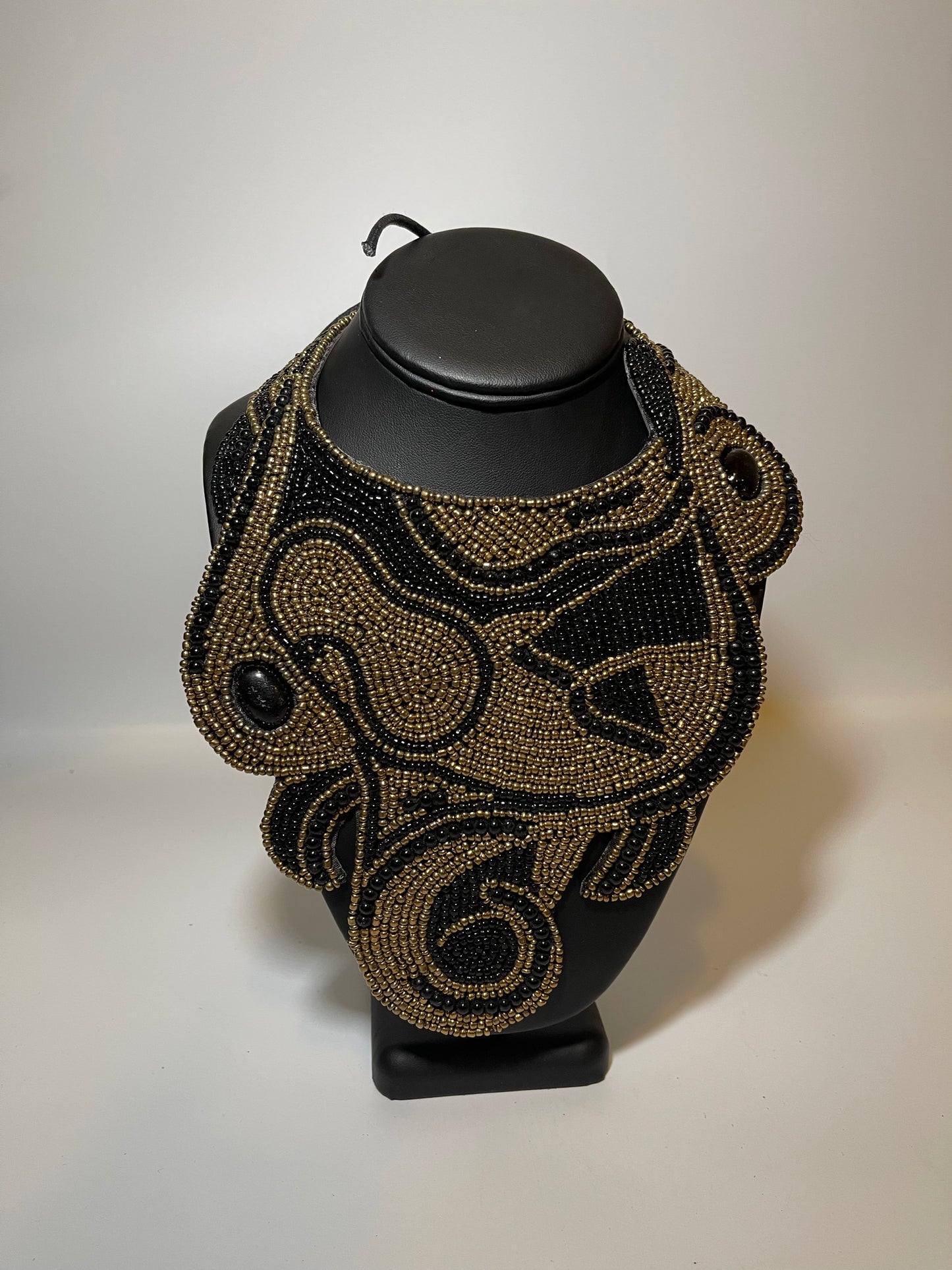 Leather Backed Black and Gold Bead Swirl Bib Necklace